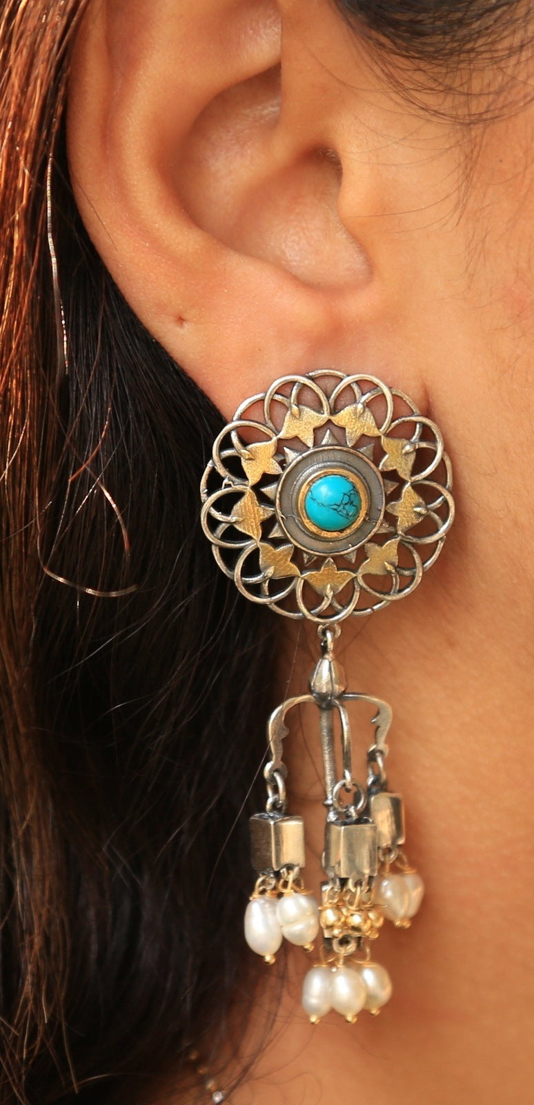 Alluring Mandala Dual tone Chandeliers - Close-up of the Mandala Dual Tone Chandeliers showcasing a dual-tone mandala design with turquoise kundan stones and rice pearl droplets. These earrings exude elegance and charm, adding a pop of vibrant color and sophistication to any ensemble.