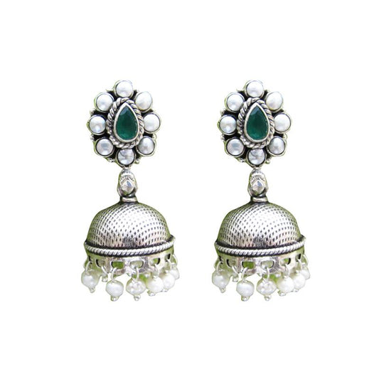 Close-up of the Akansha Pearl Silver Jhumkas featuring emerald and pearl kundan work, pearl droplets, and textured silver surface. These earrings exude elegance and sophistication, adding a touch of glamour to any ensemble.