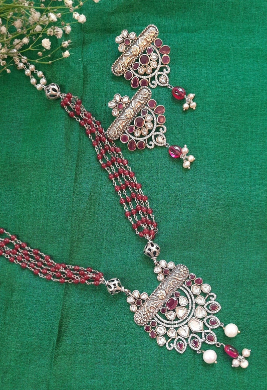 Palash Jadau Necklace - Silver set with artificial Polki stones, red mani beads, maroon sujni, and pearls, exuding an ethnic and timeless look.