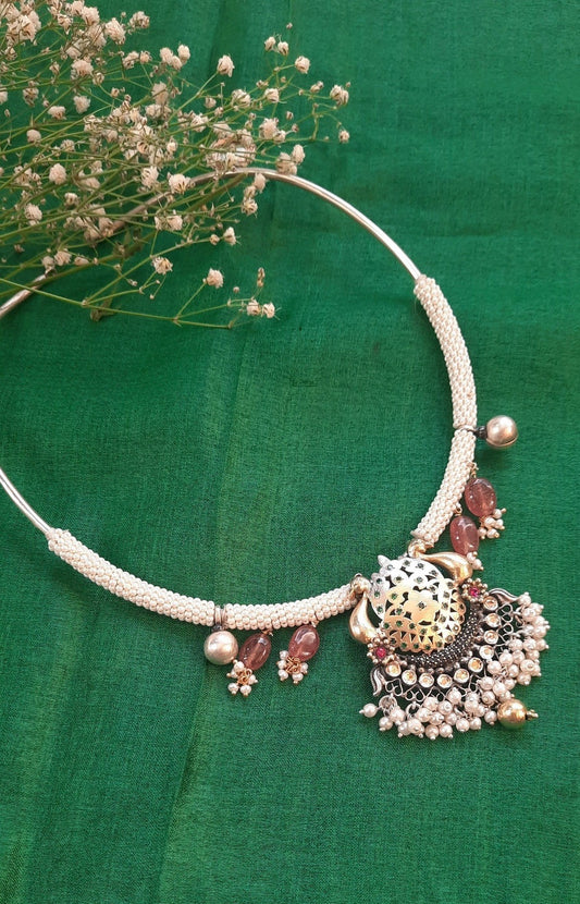 A close-up of the Aarya Necklace, showcasing its two-tone design, pearls, and Sujni work. The necklace is beautifully crafted with intricate detailing and a unique arrangement of pearls, exuding elegance and charm.